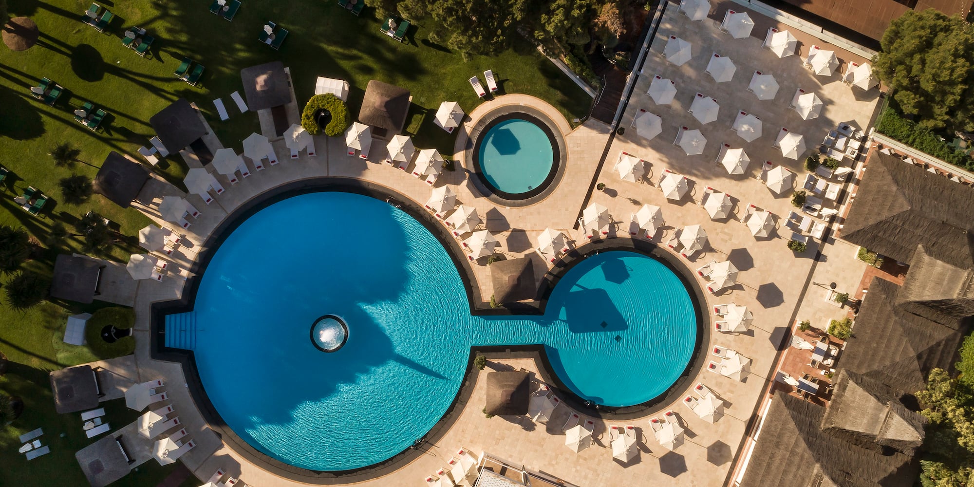 a pool with chairs and umbrellas