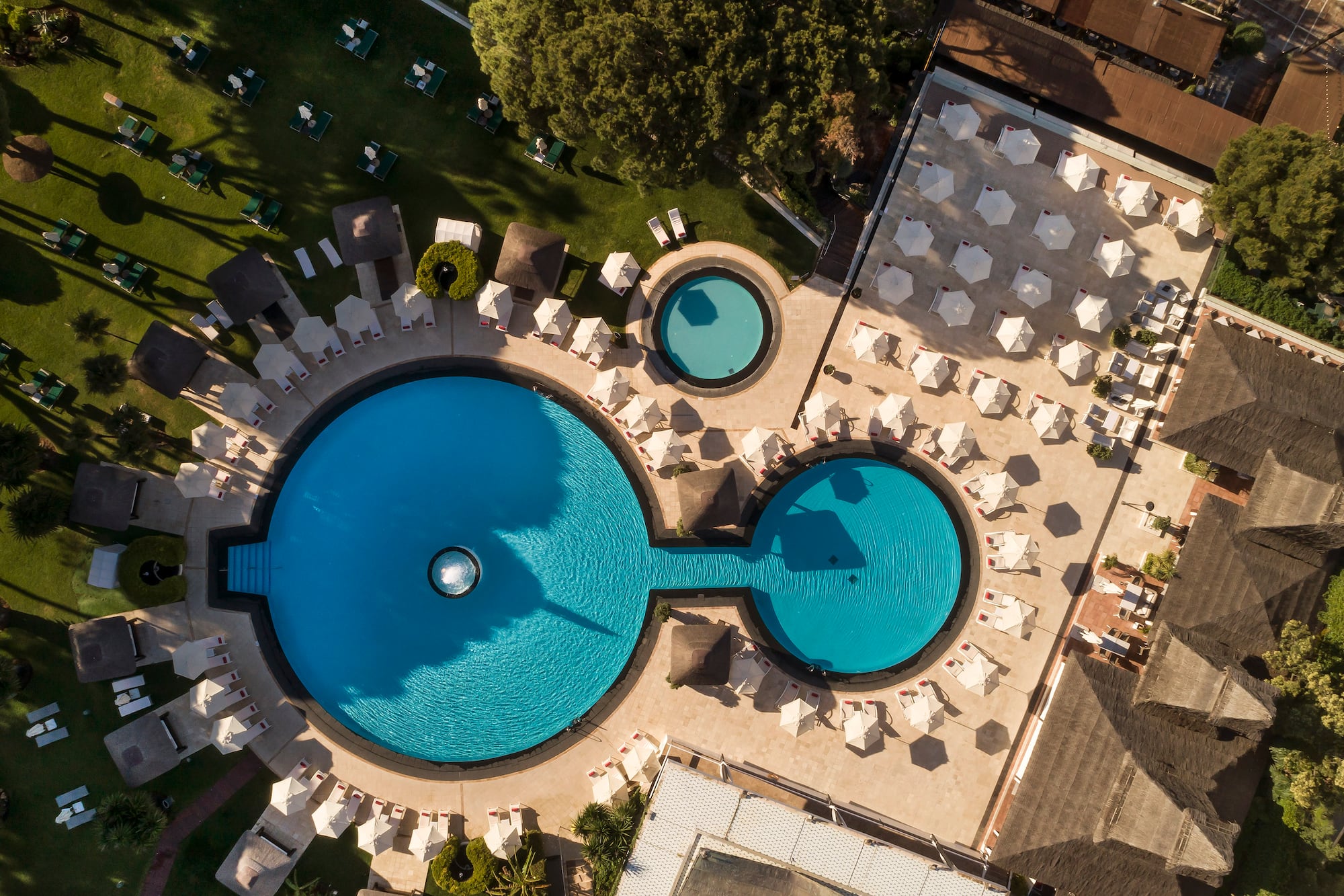 a pool with chairs and umbrellas