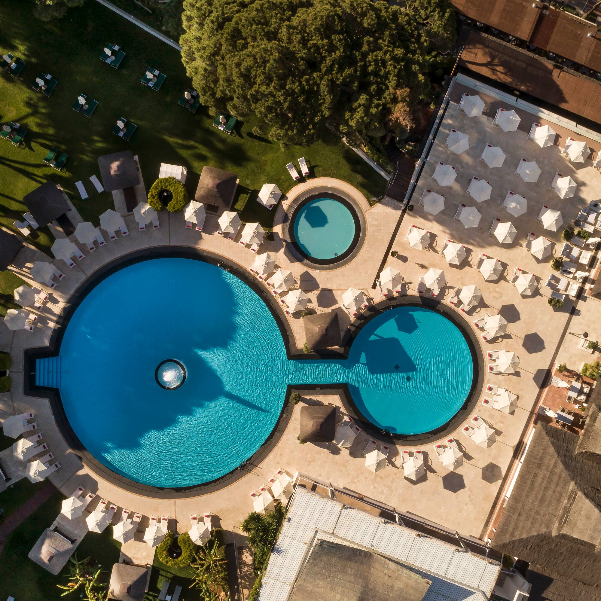a pool with chairs and umbrellas