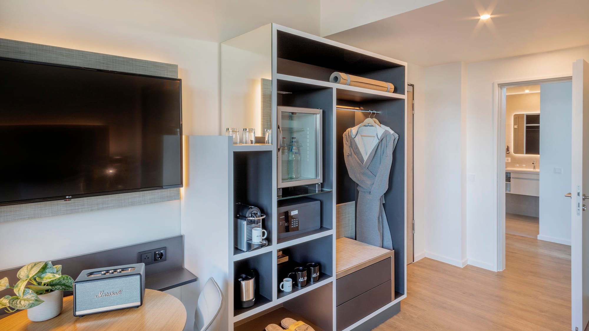 a room with a tv and a shelf