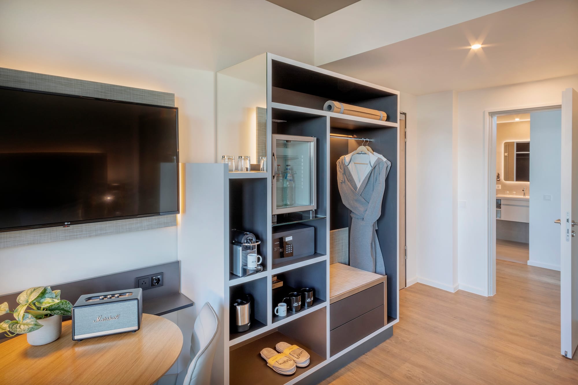 a room with a tv and a shelf