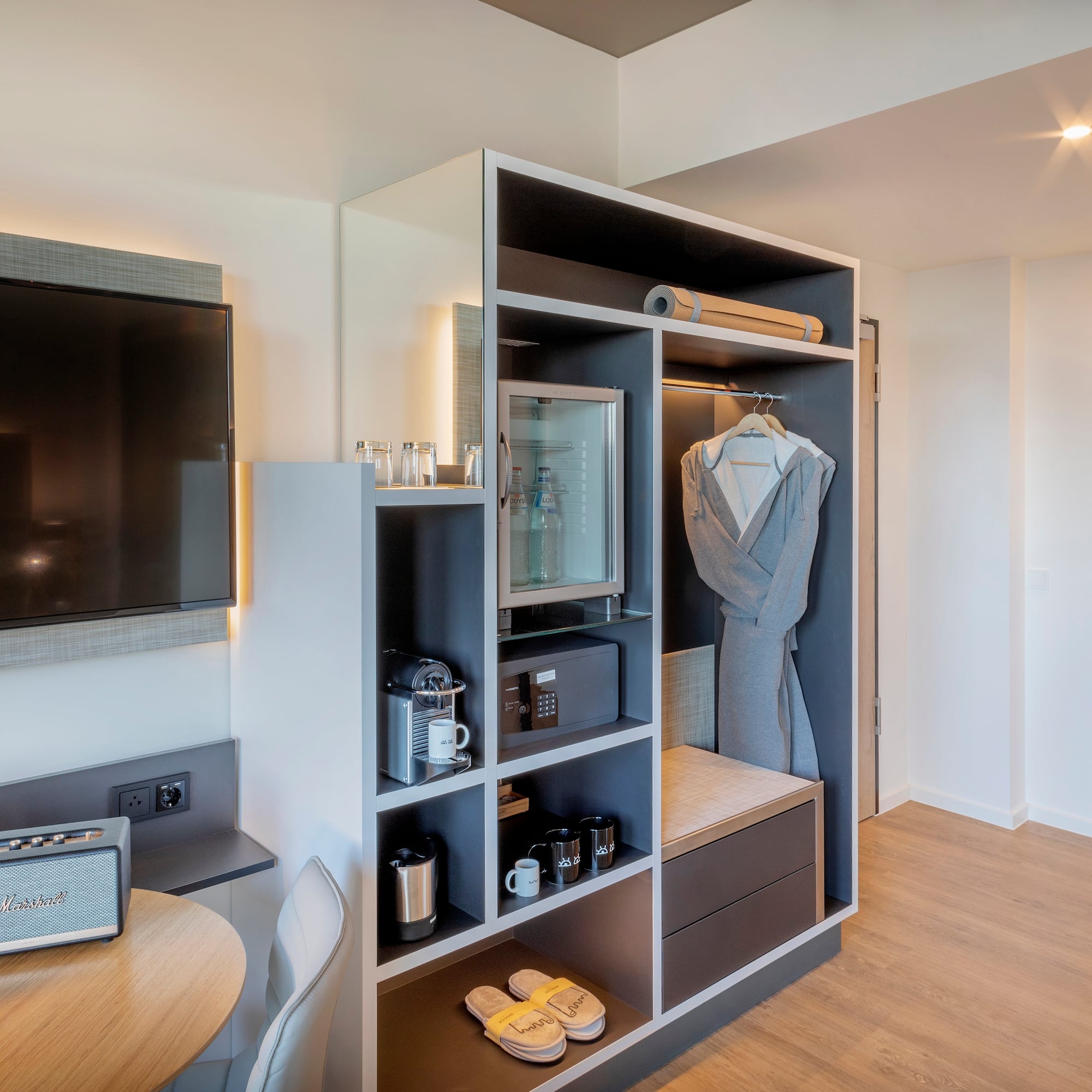 a room with a tv and a shelf