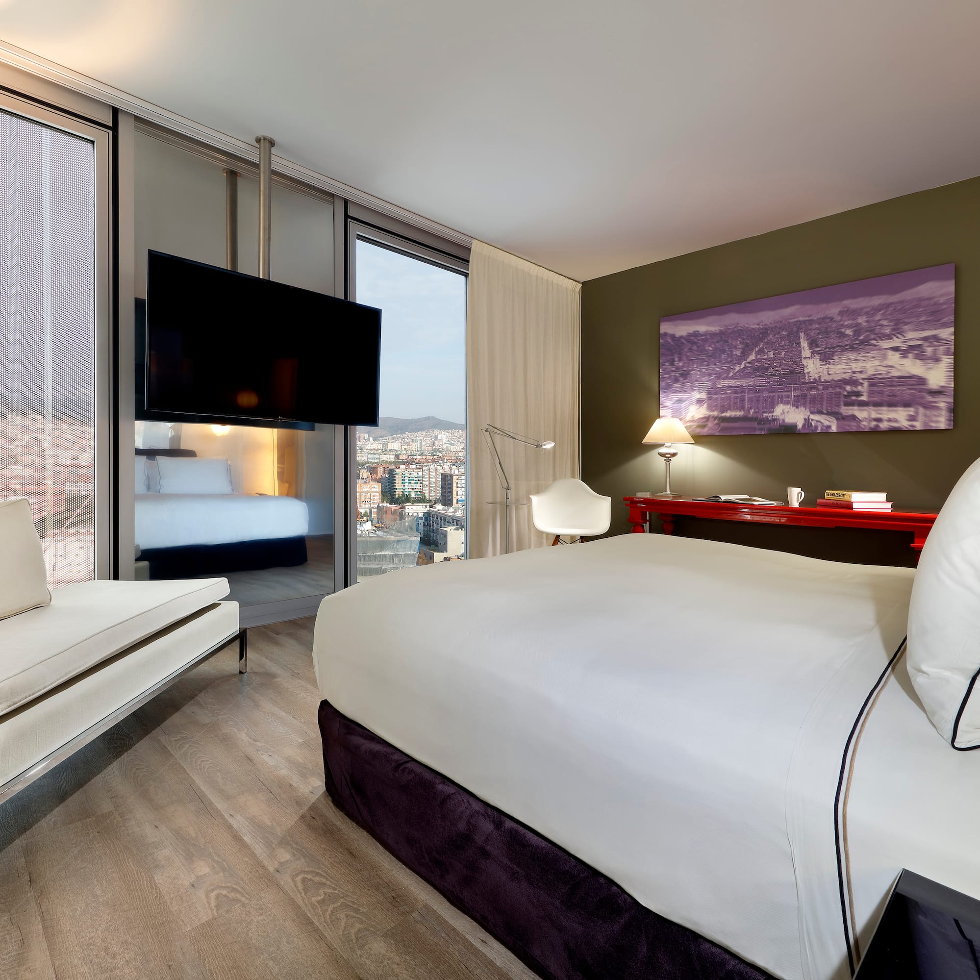 a room with a bed and a television