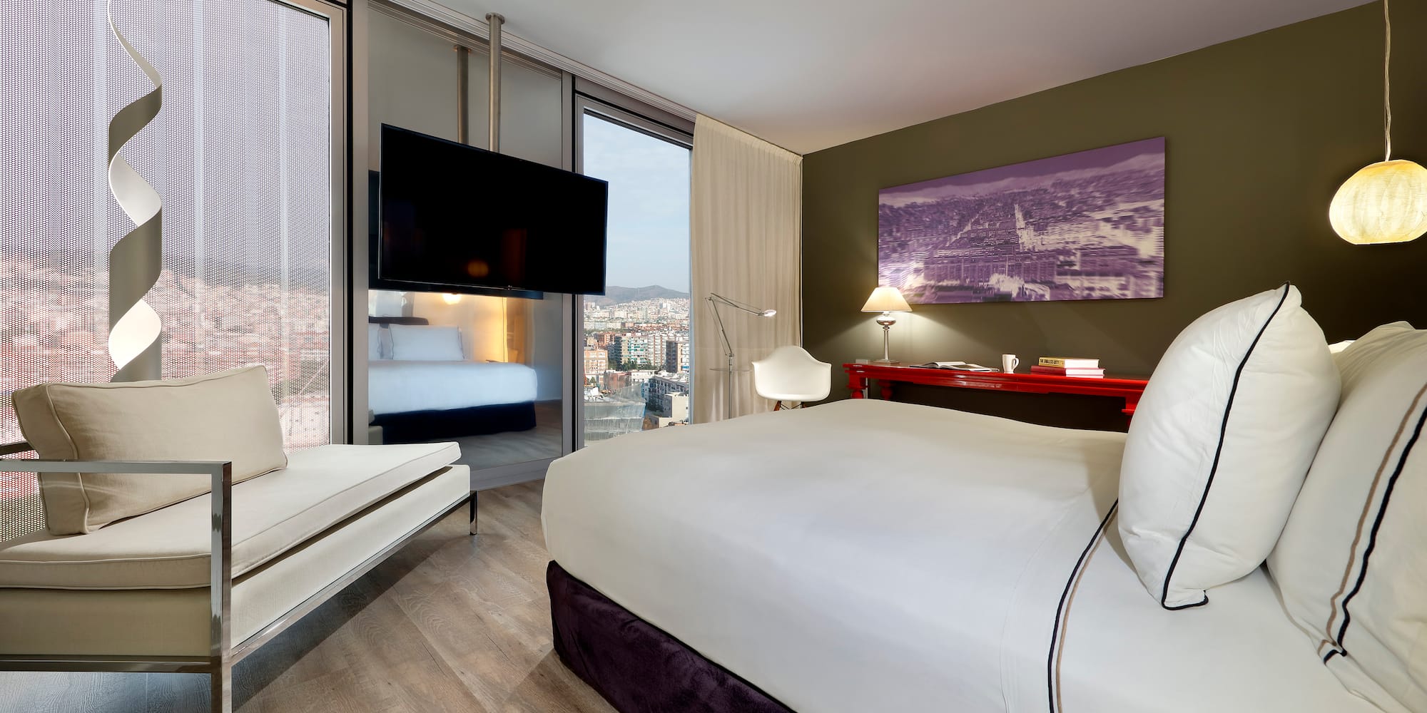 a room with a bed and a television