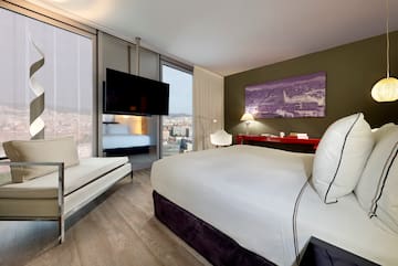 a room with a bed and a television