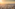 Vista aérea de París al atardecer con la Torre Eiffel y rascacielos.