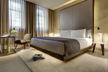 a bedroom with a bed and a chair