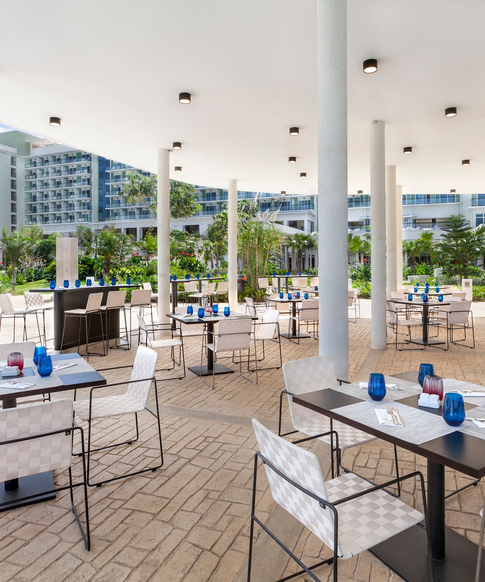a patio with tables and chairs
