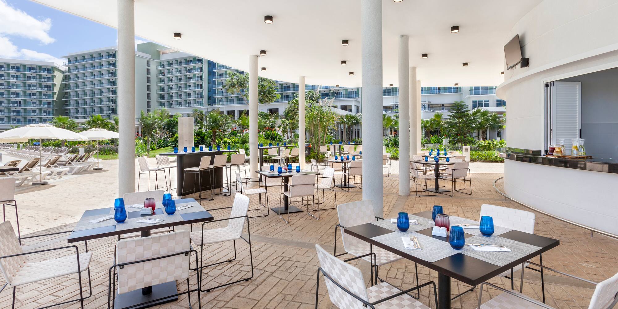 a patio with tables and chairs