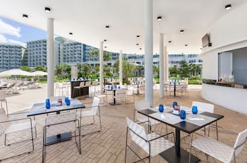 a patio with tables and chairs