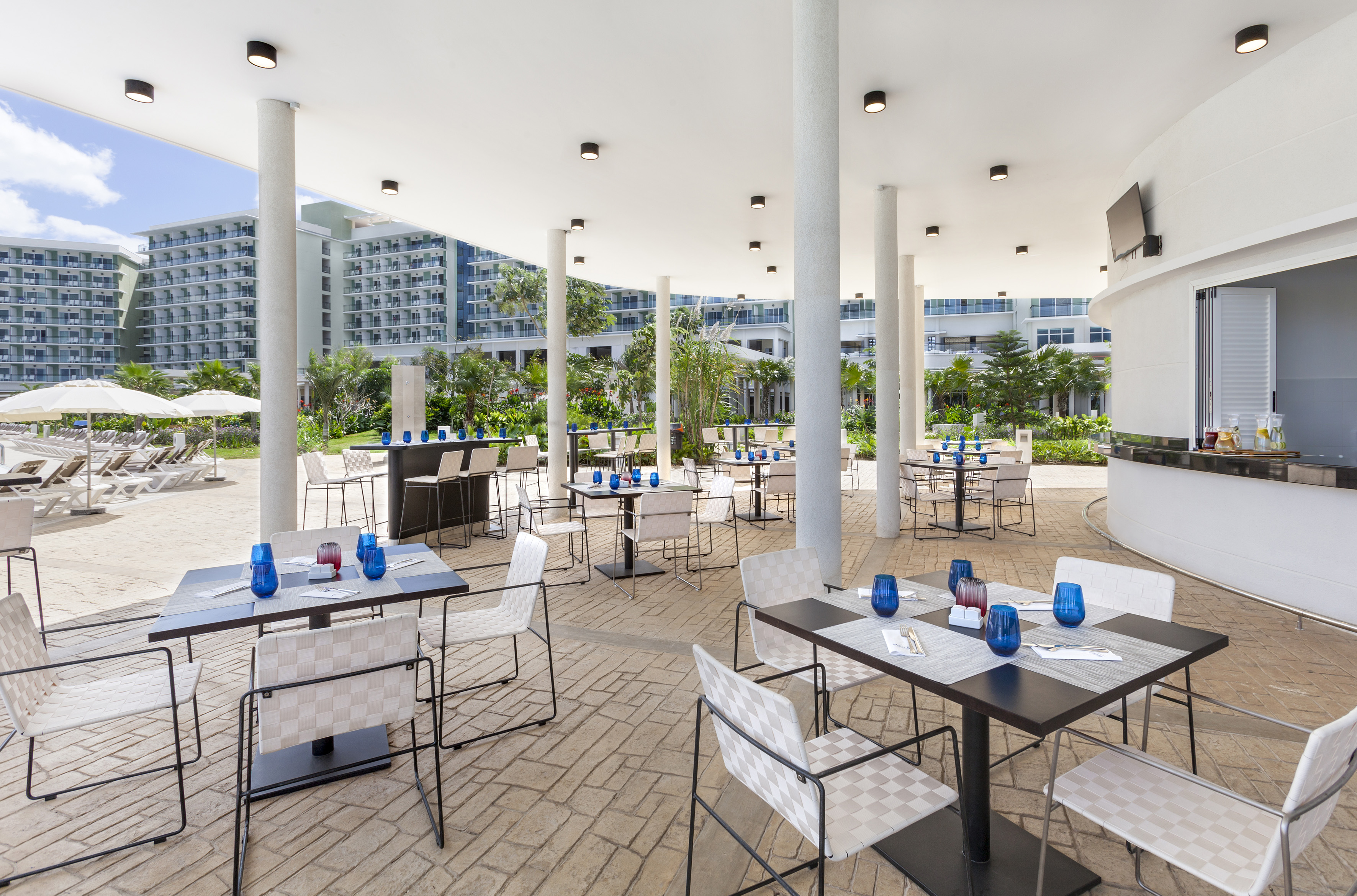 a patio with tables and chairs