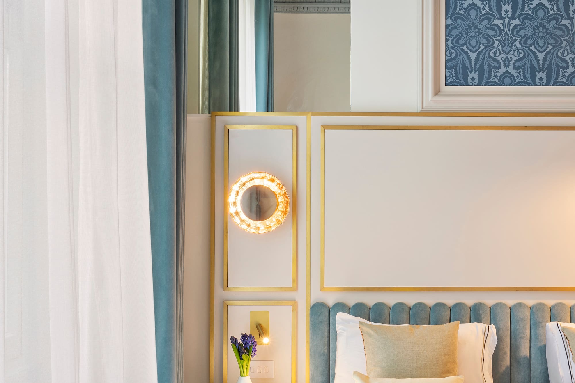 a bed with a mirror and a tray of flowers