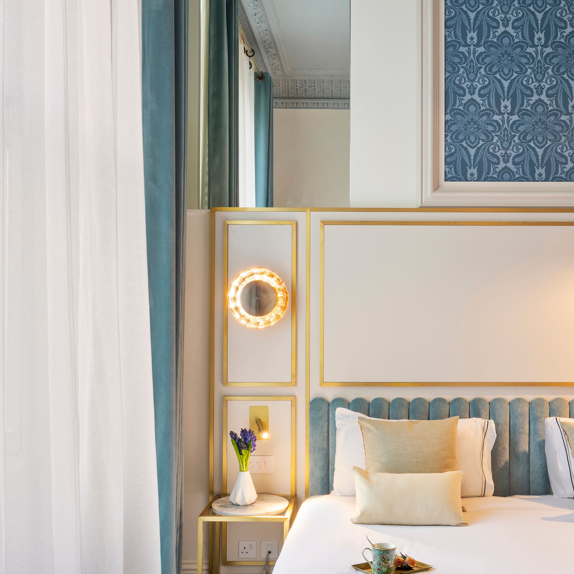 a bed with a mirror and a tray of flowers