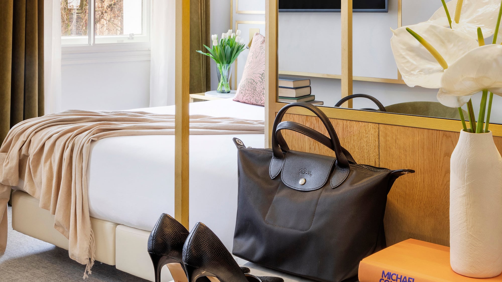 a room with a bed and a bed and a bed with a bed and a mirror