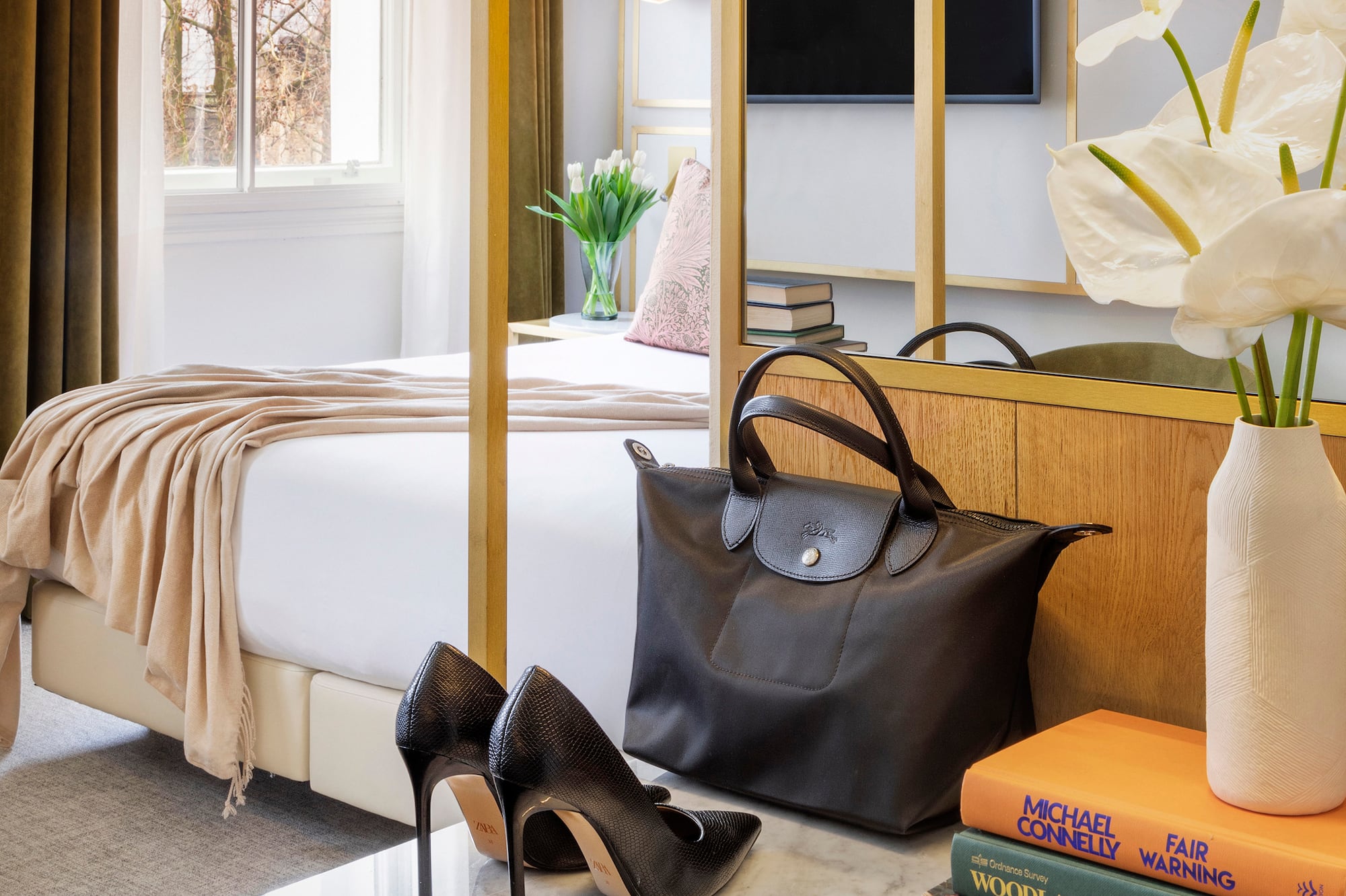 a room with a bed and a bed and a bed with a bed and a mirror