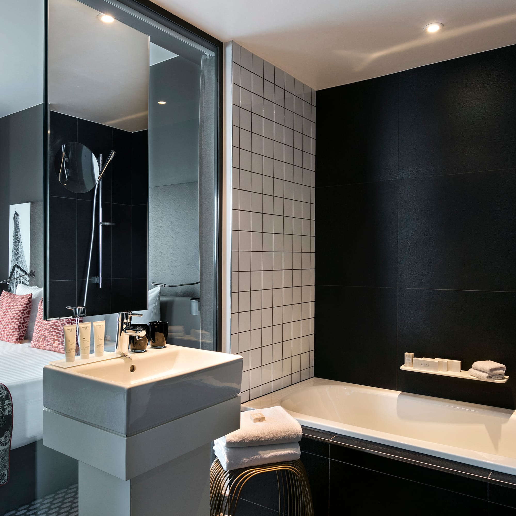 a bathroom with a bed and bathtub