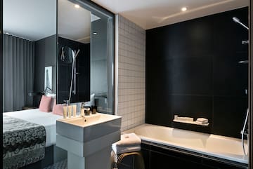 a bathroom with a bed and bathtub