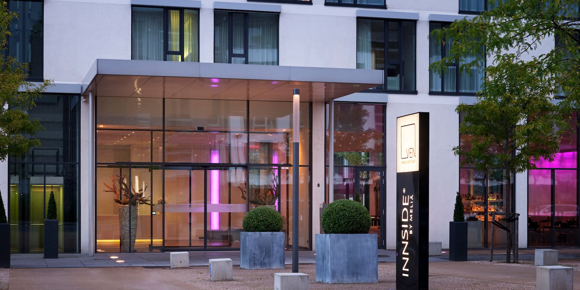 a building with glass walls and a sign