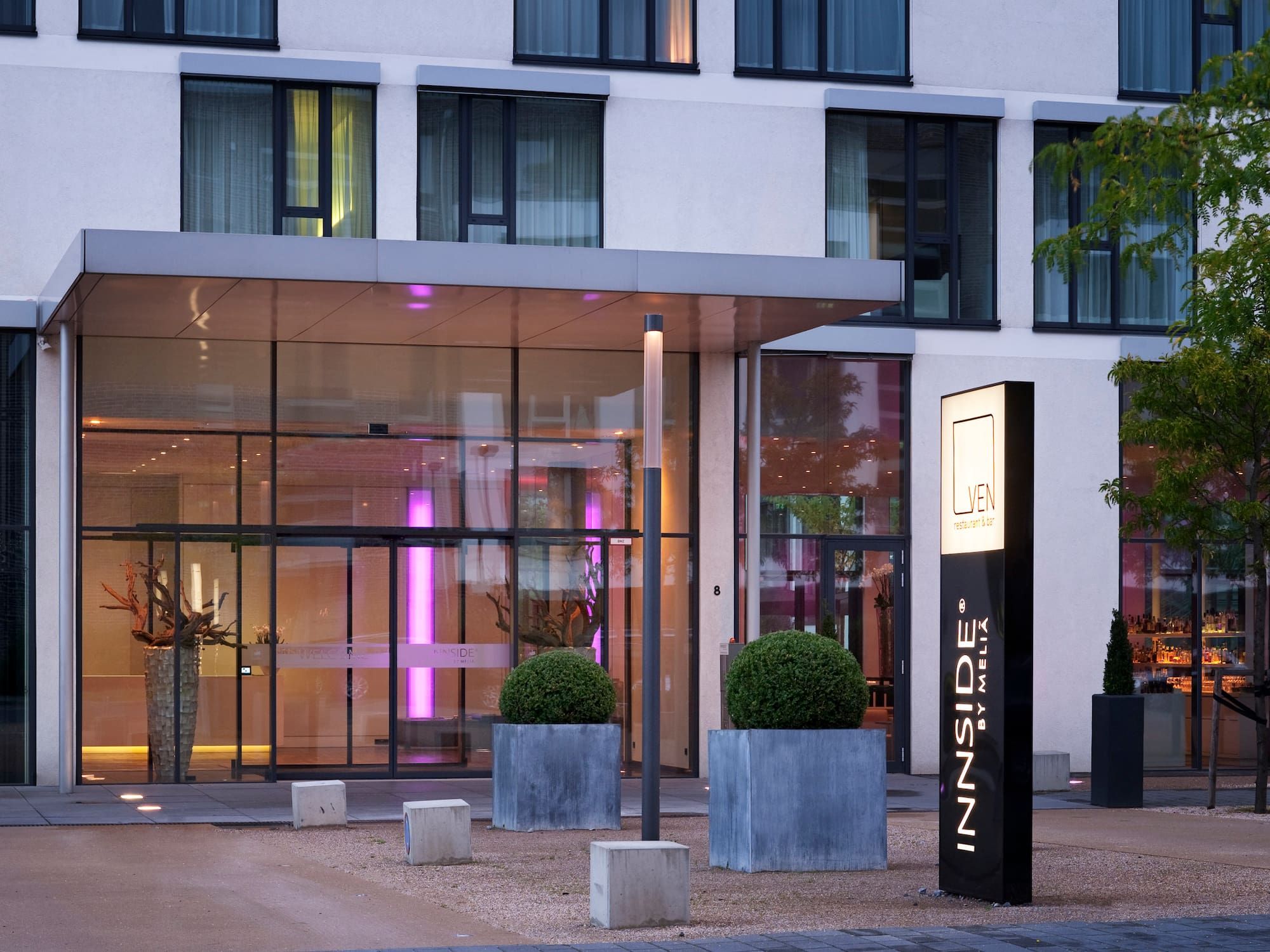 a building with glass walls and a sign