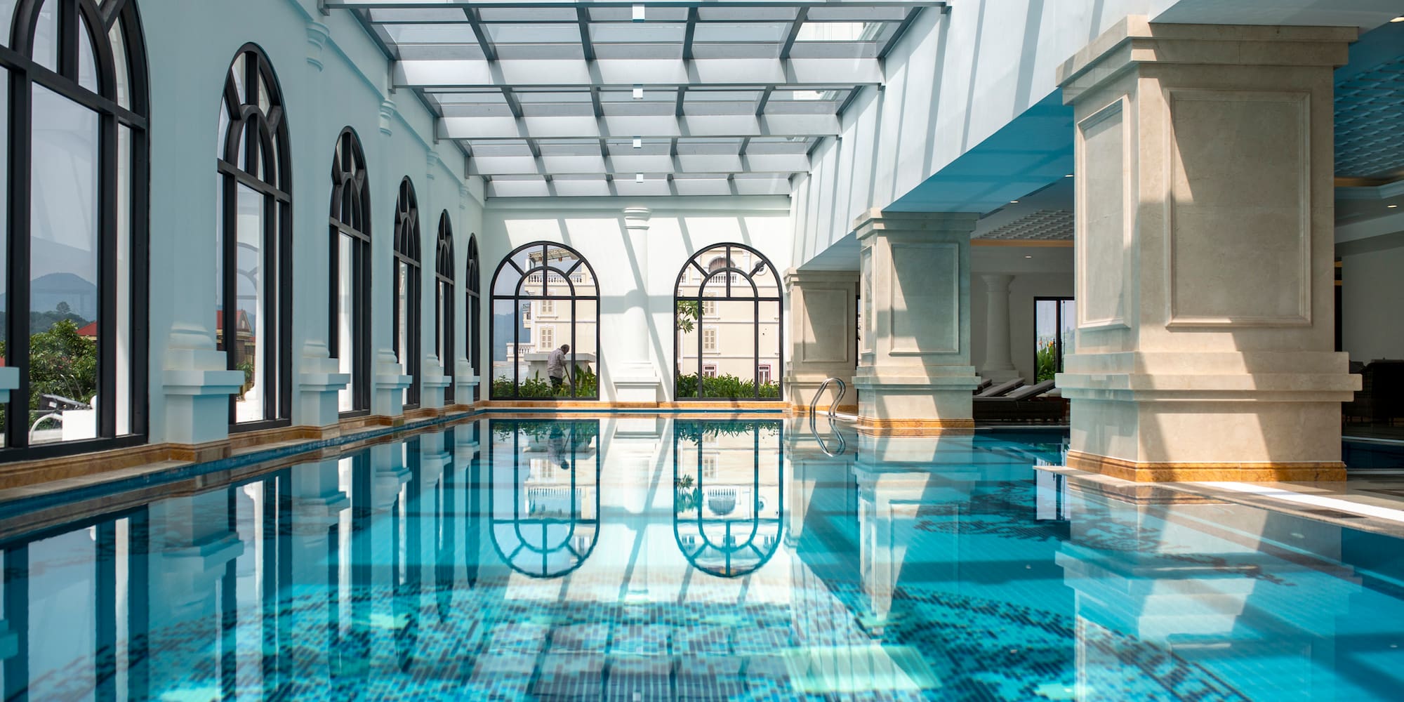a indoor pool with a glass roof