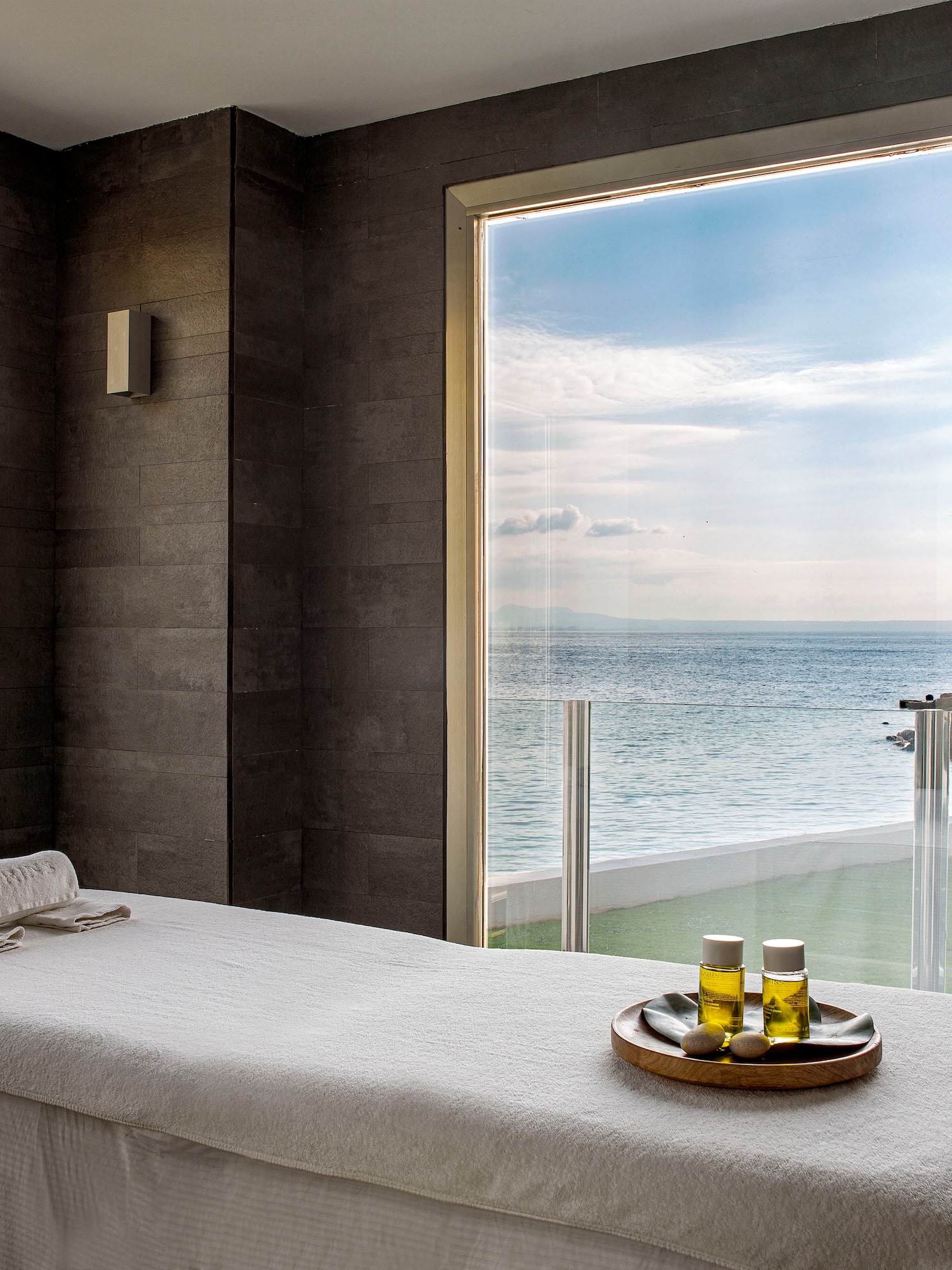 a massage table with a tray of oil on it