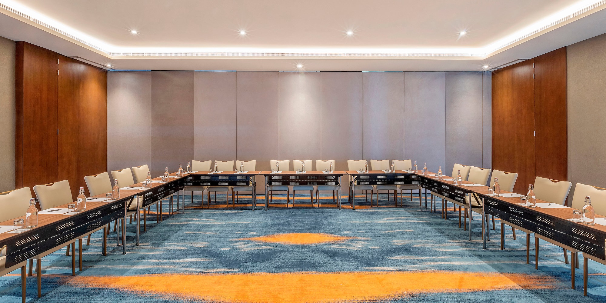 a room with a long table and chairs