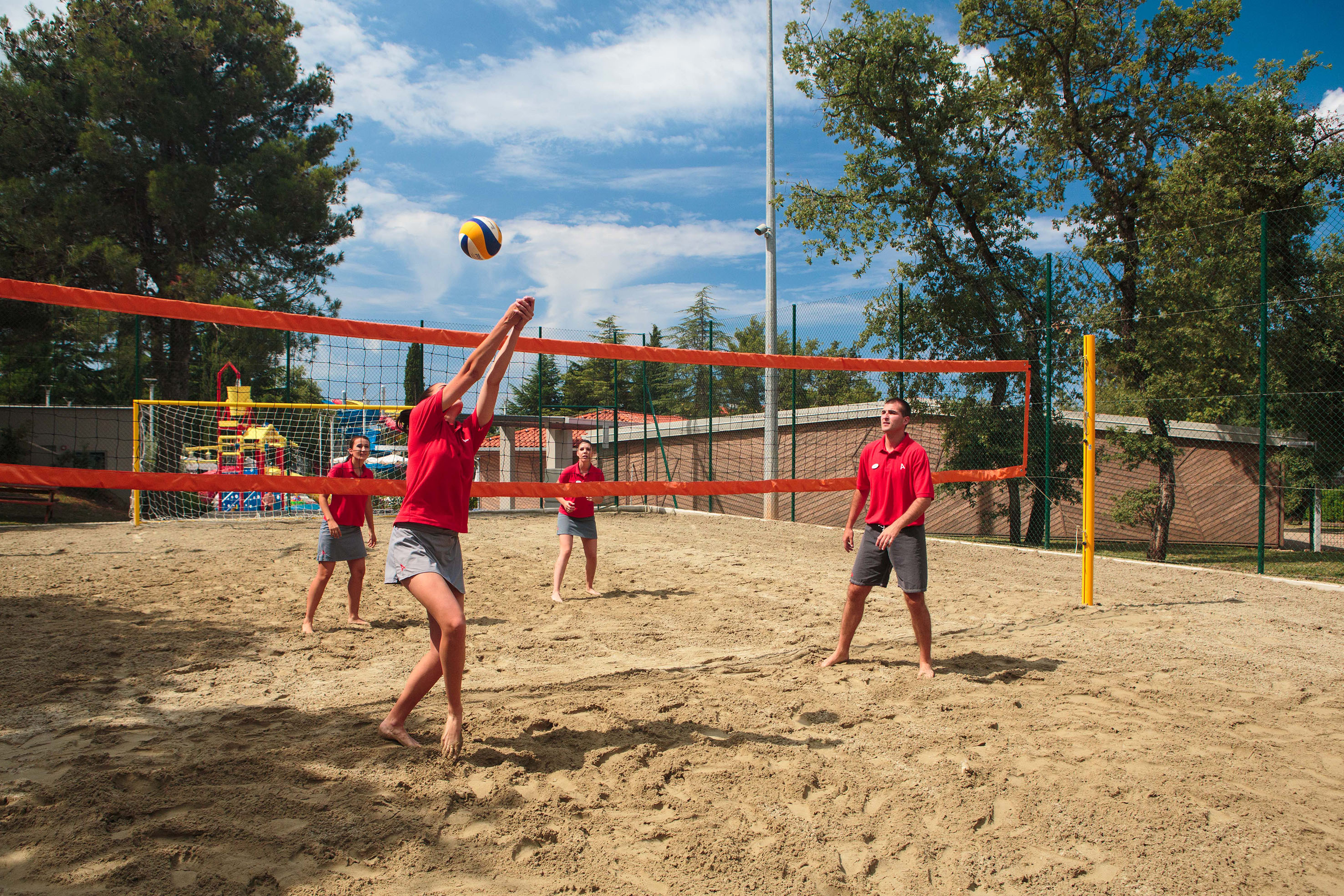 a group of people playing volleyball