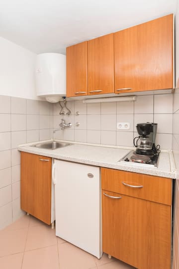 a kitchen with a sink and a coffee maker