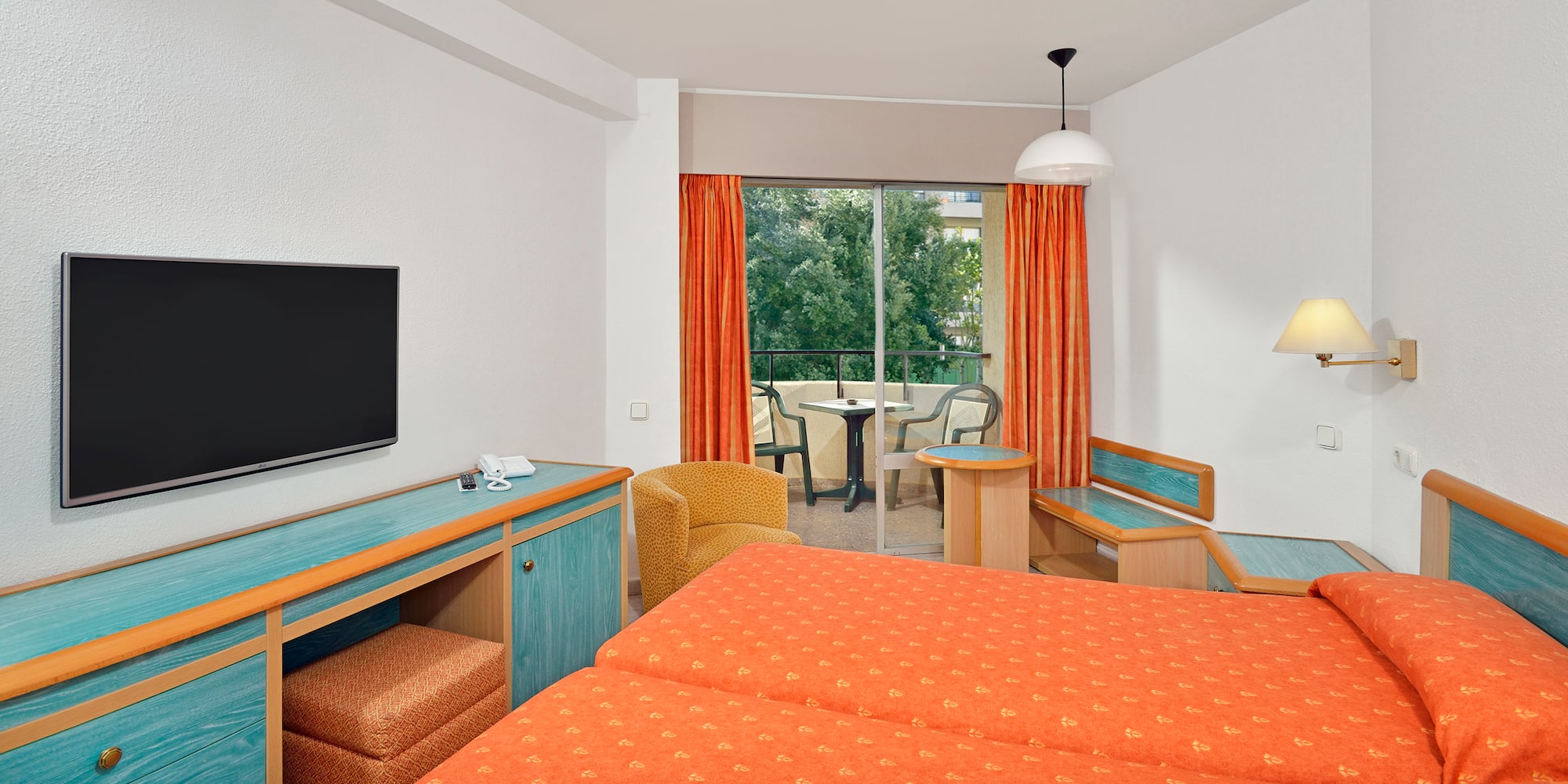 a room with two beds and a television