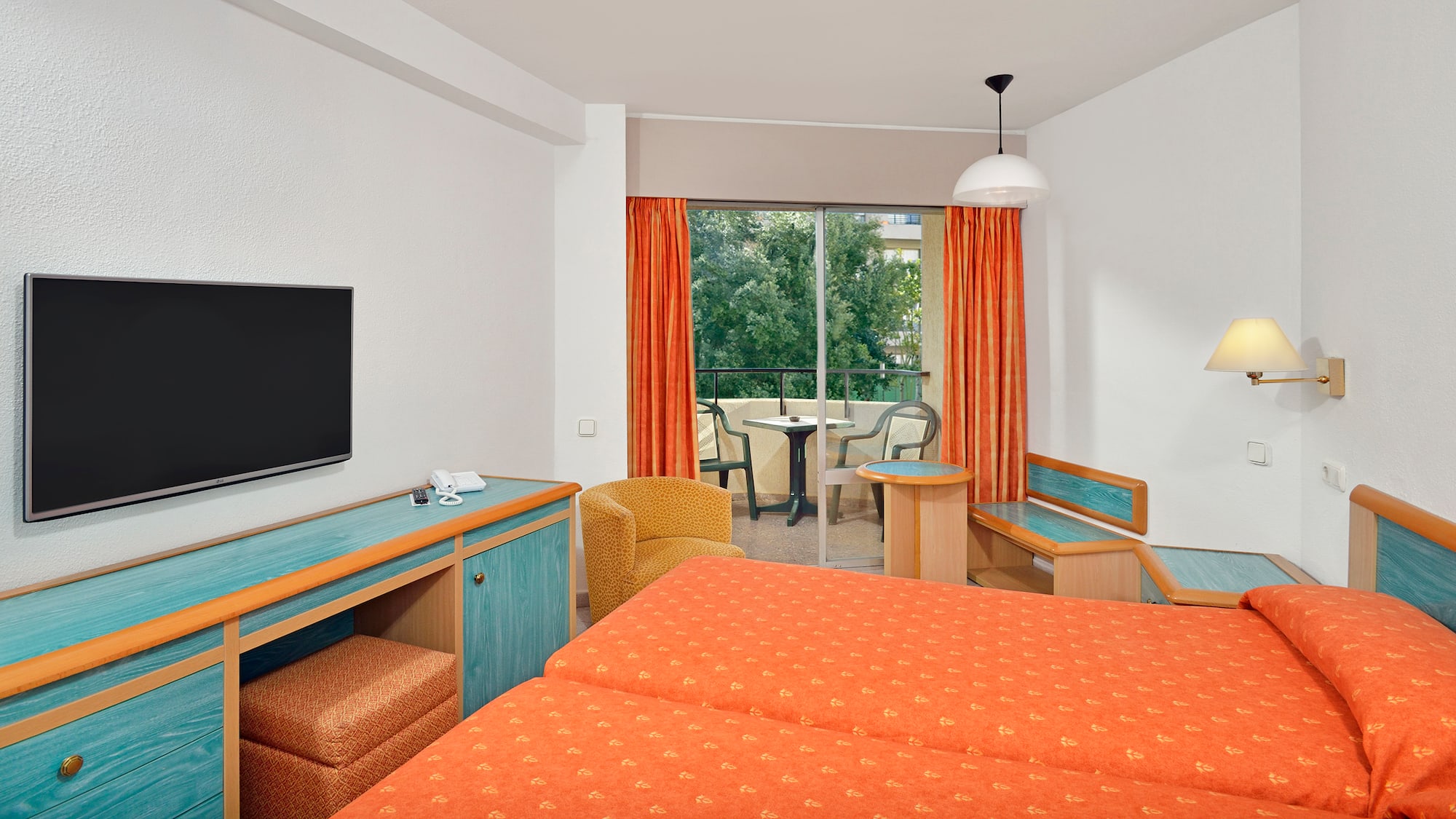 a room with two beds and a television