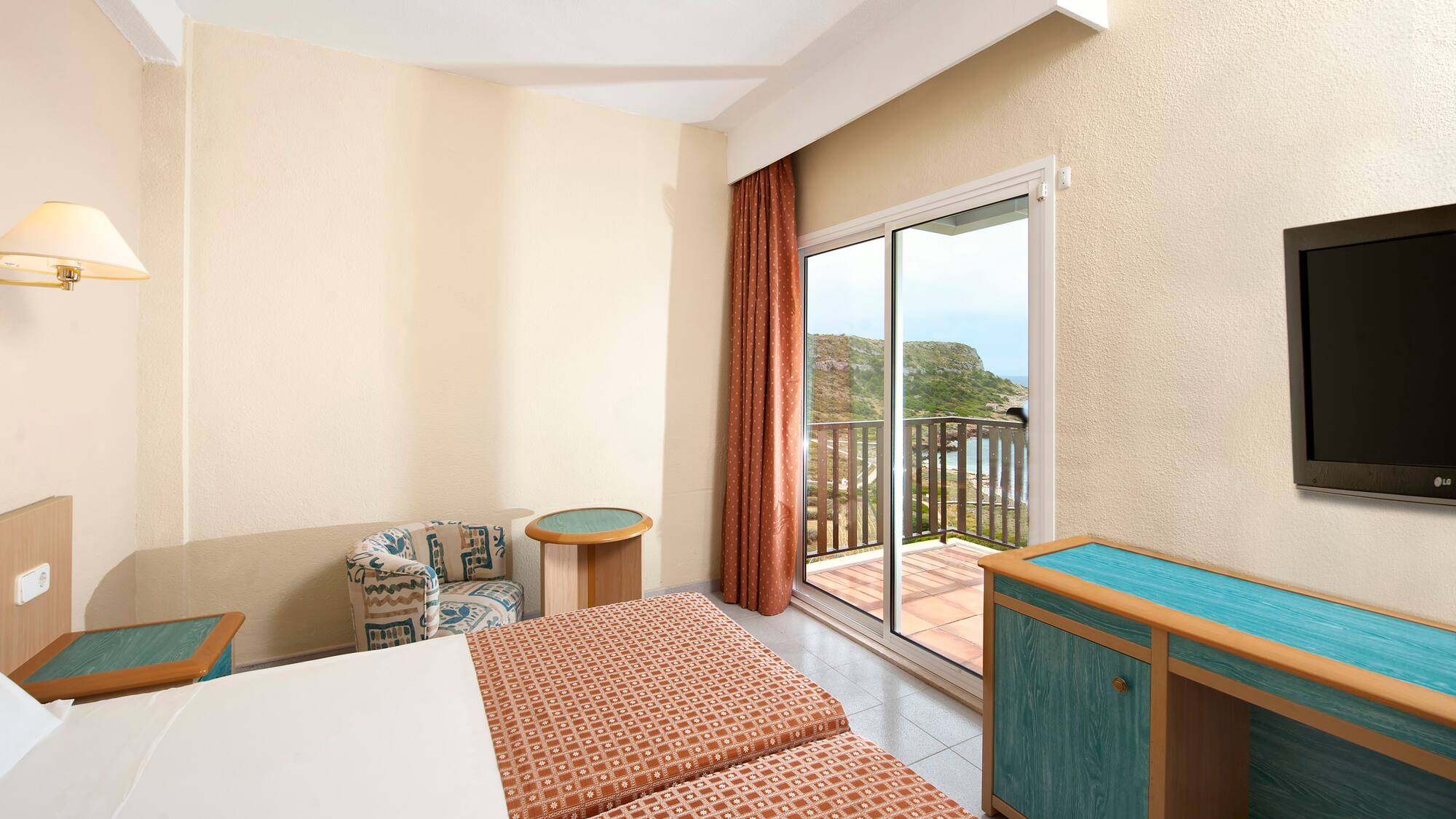 a room with two beds and a glass door