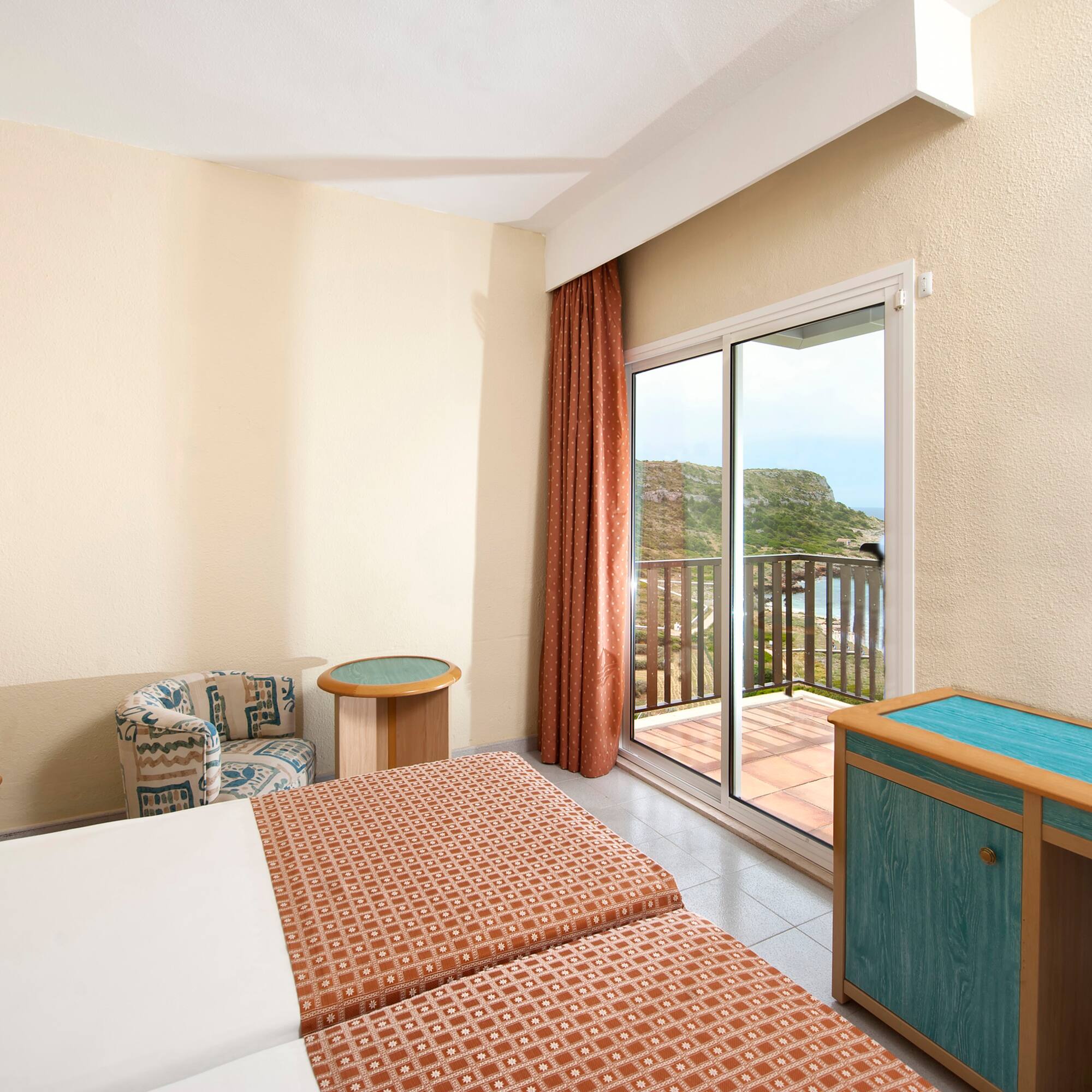 a room with two beds and a glass door