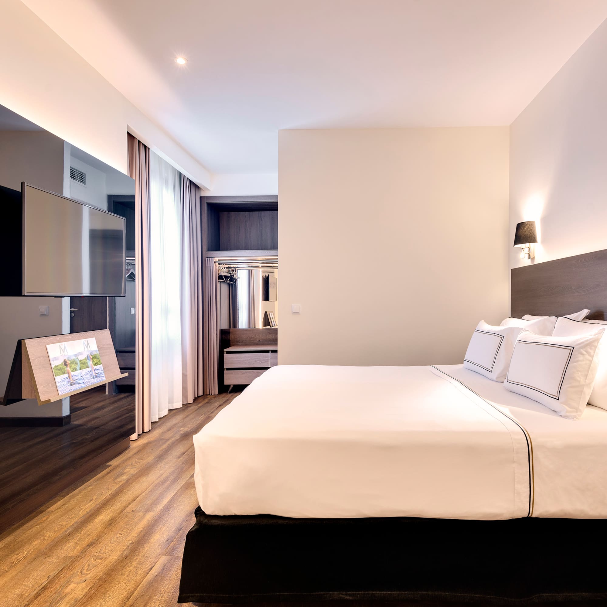 a room with a bed and a television