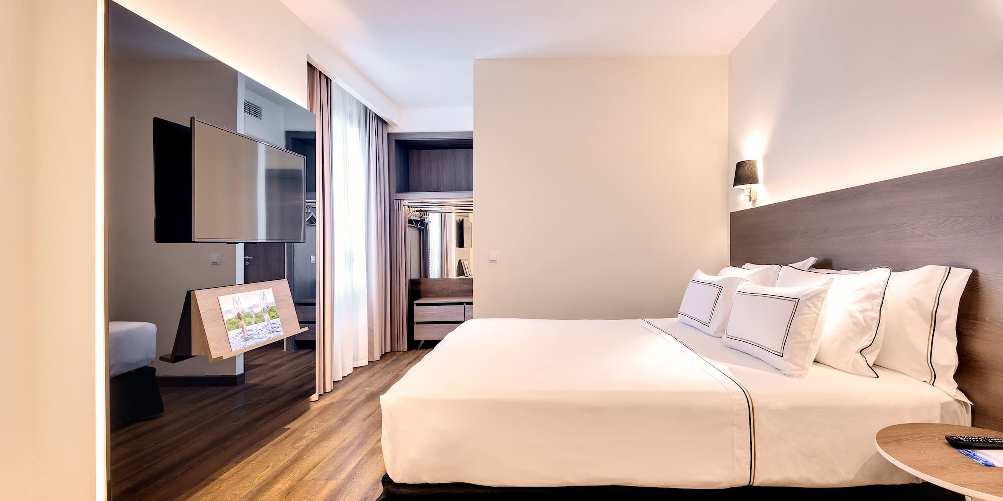 a room with a bed and a television