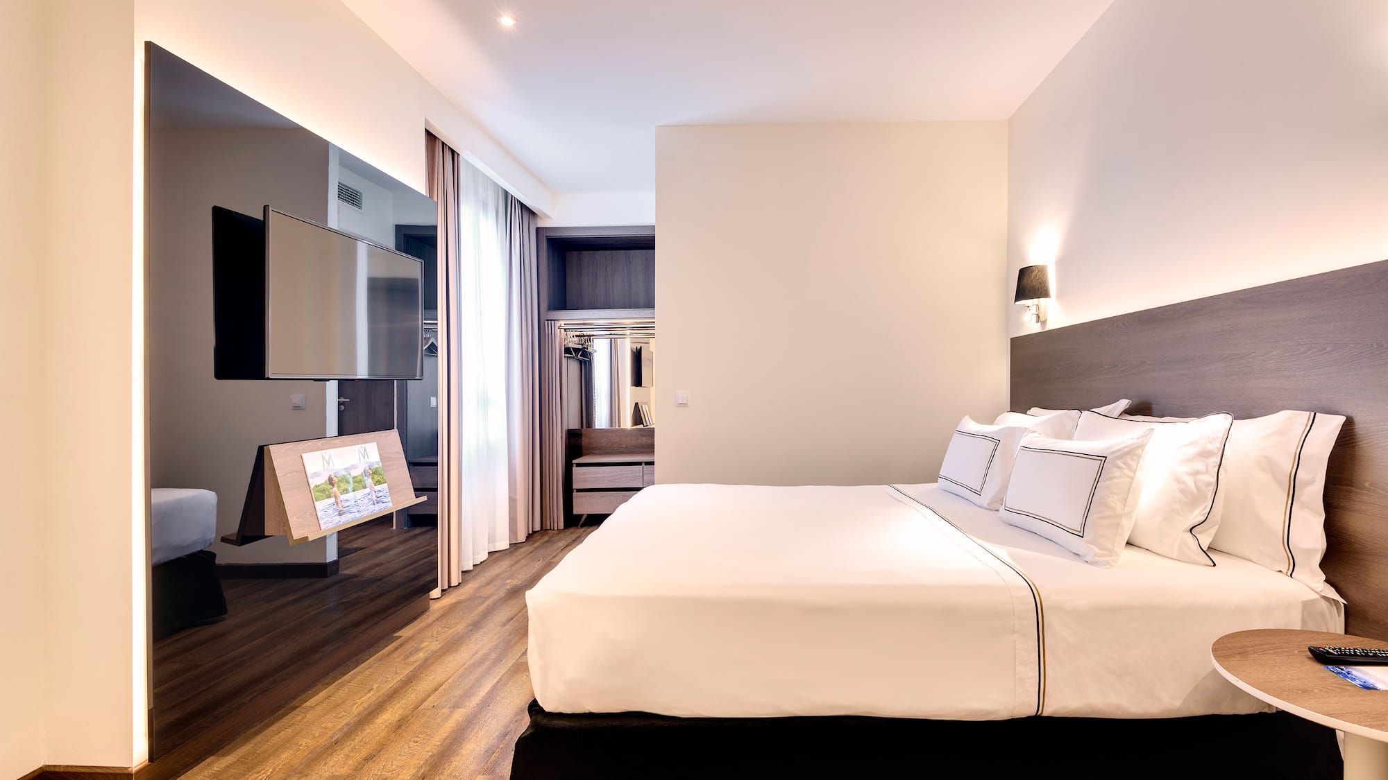 a room with a bed and a television