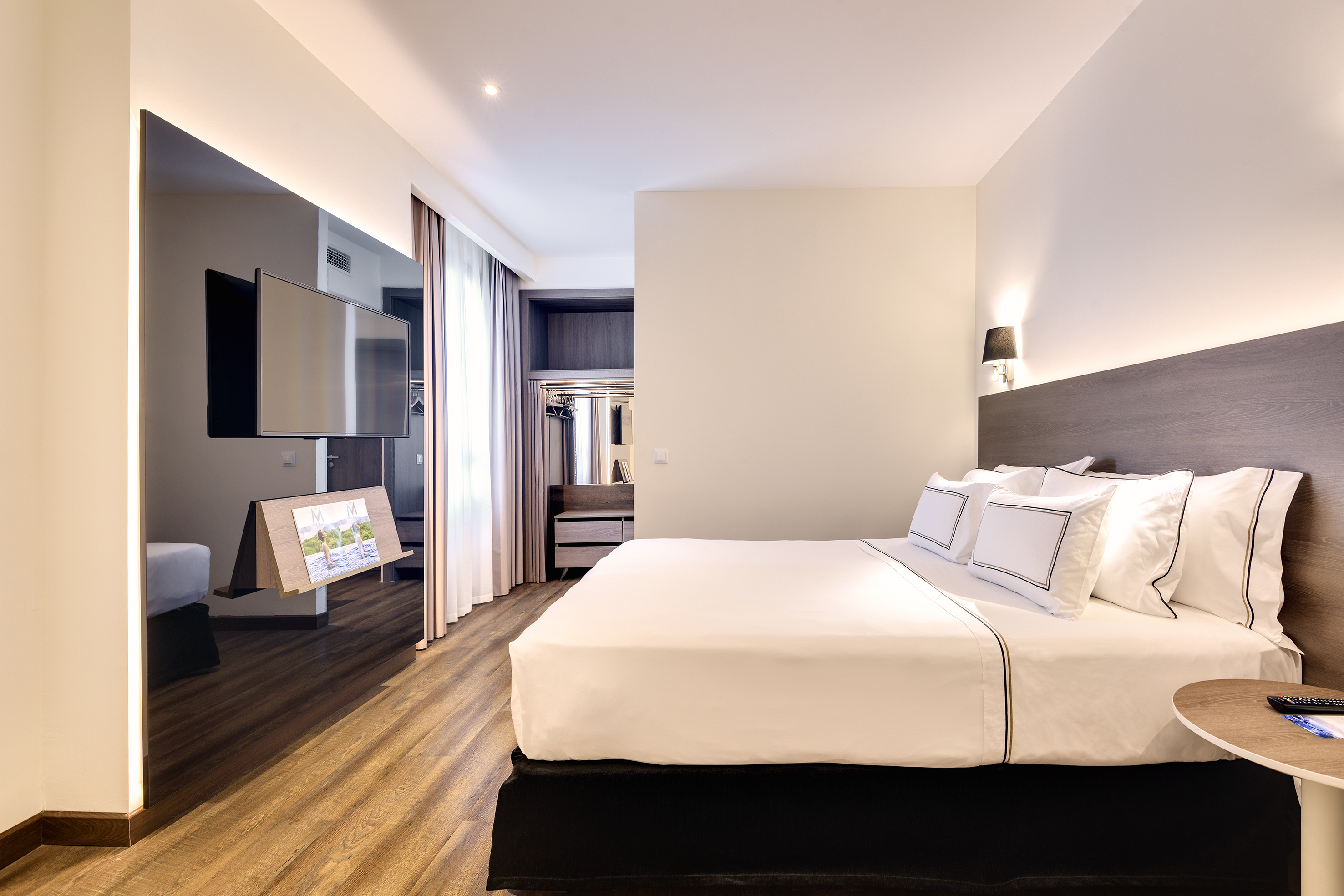 a room with a bed and a television