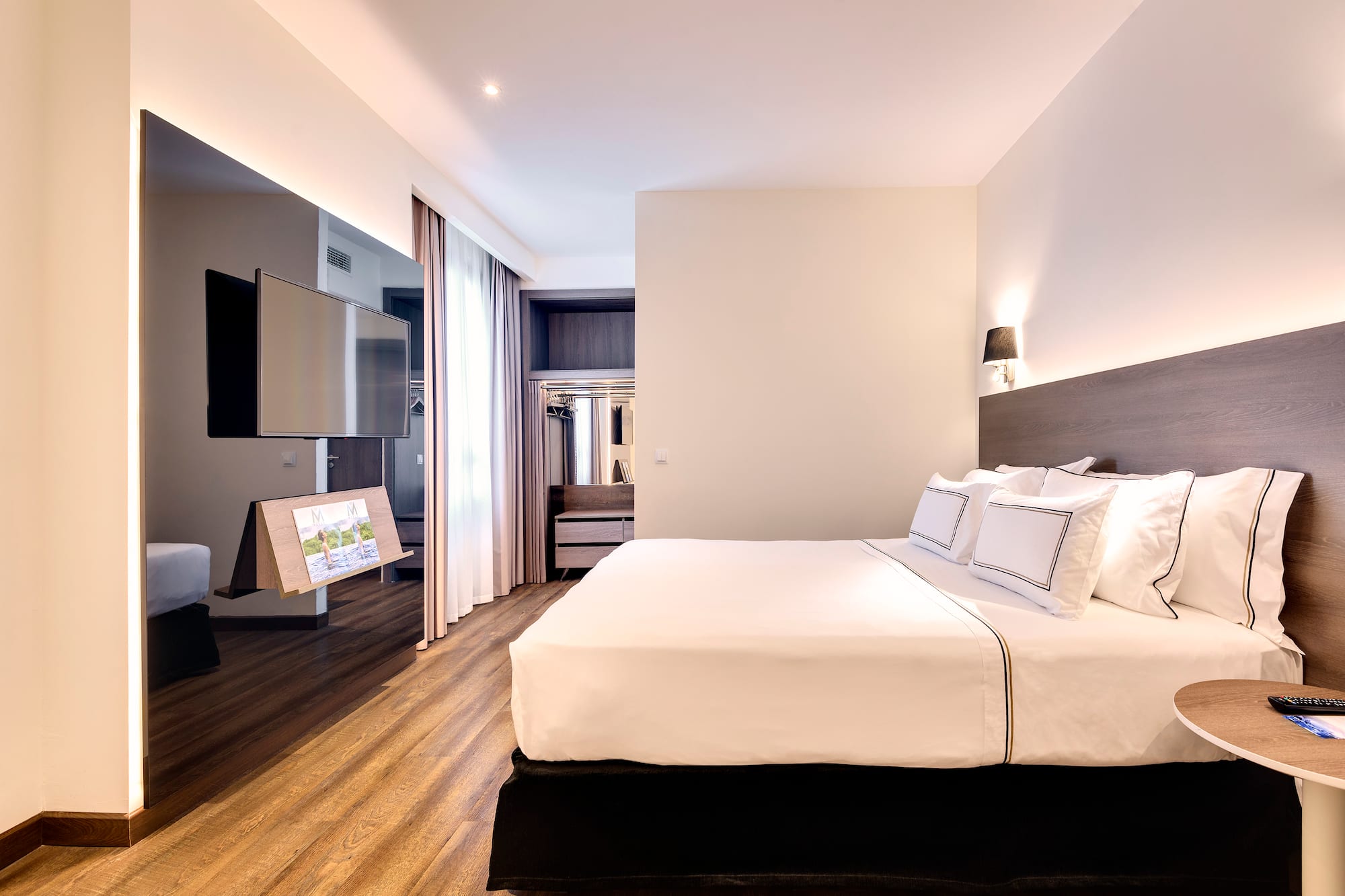 a room with a bed and a television