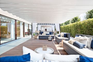 a patio with furniture and a white canopy