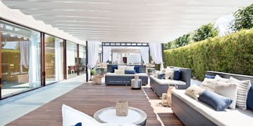 a patio with furniture and a white canopy