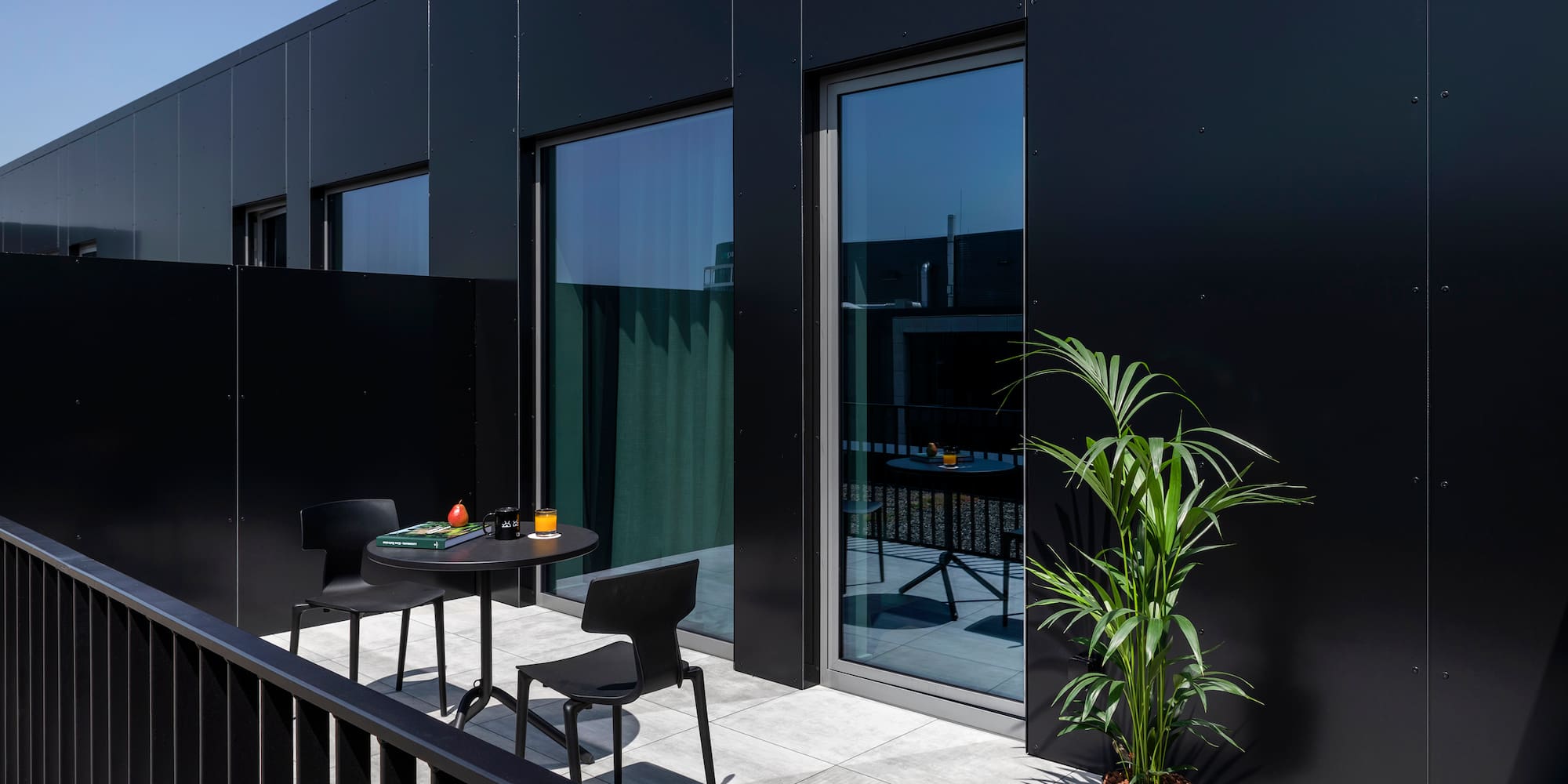 a black building with a table and chairs