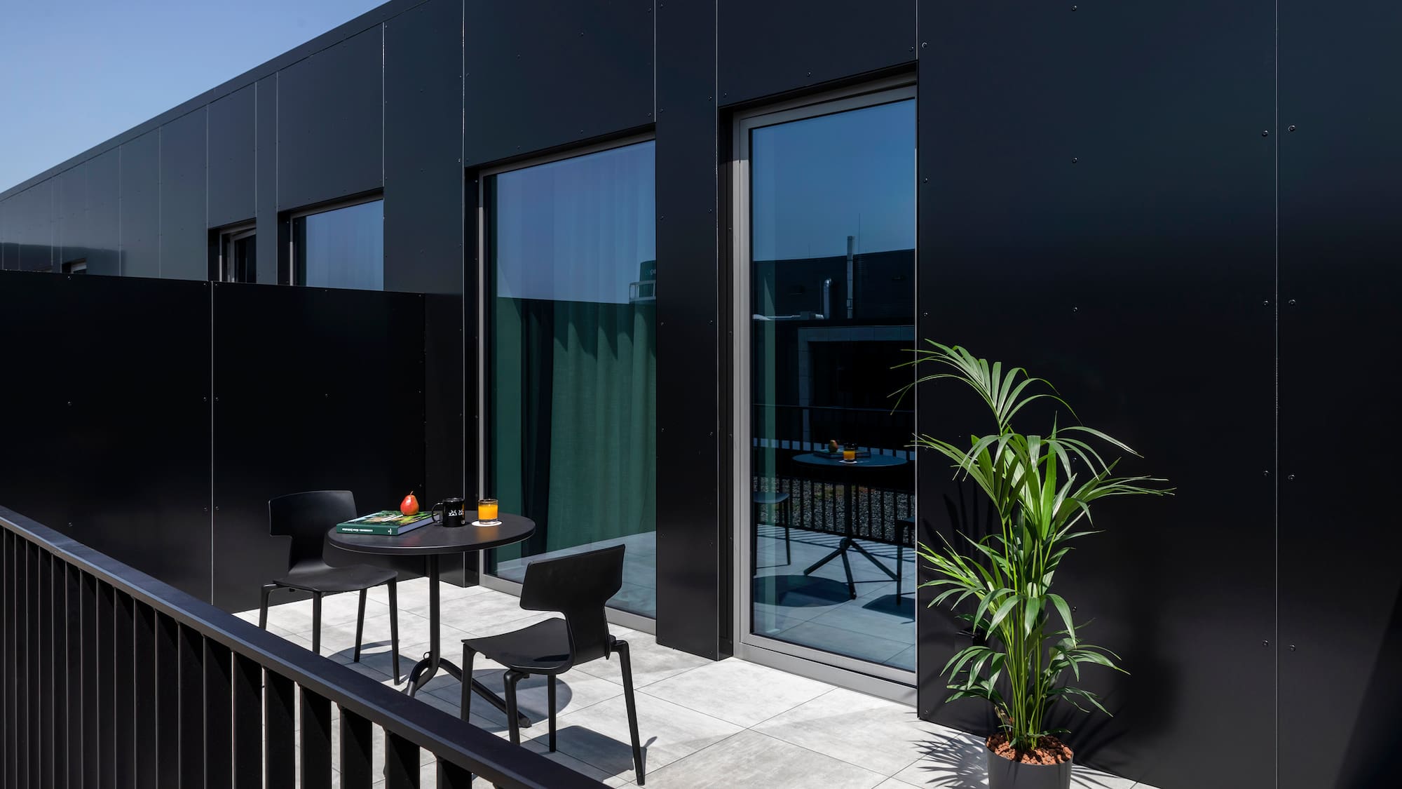 a black building with a table and chairs
