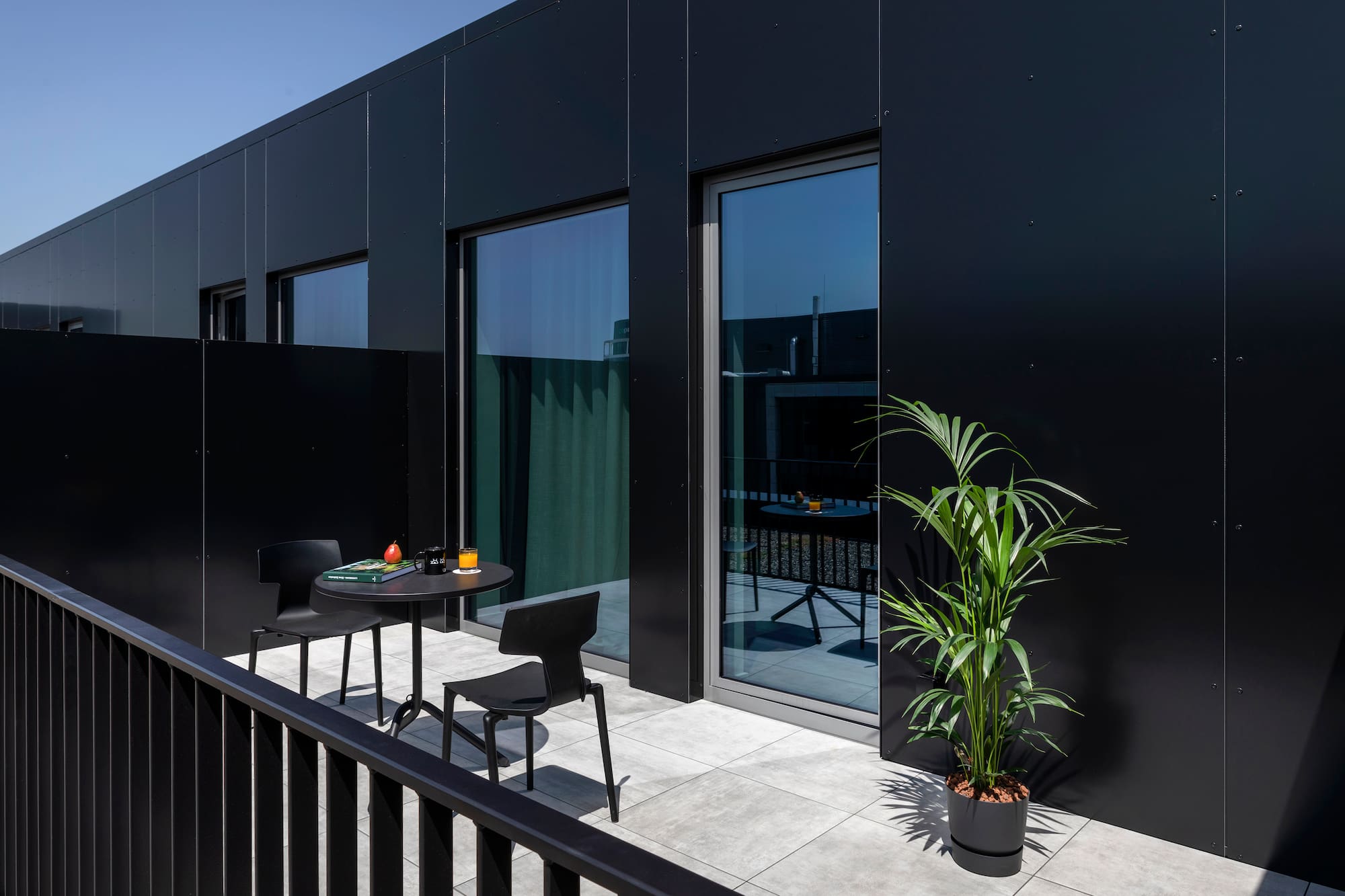 a black building with a table and chairs