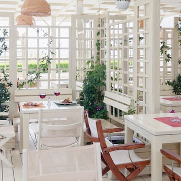 a white room with tables and chairs