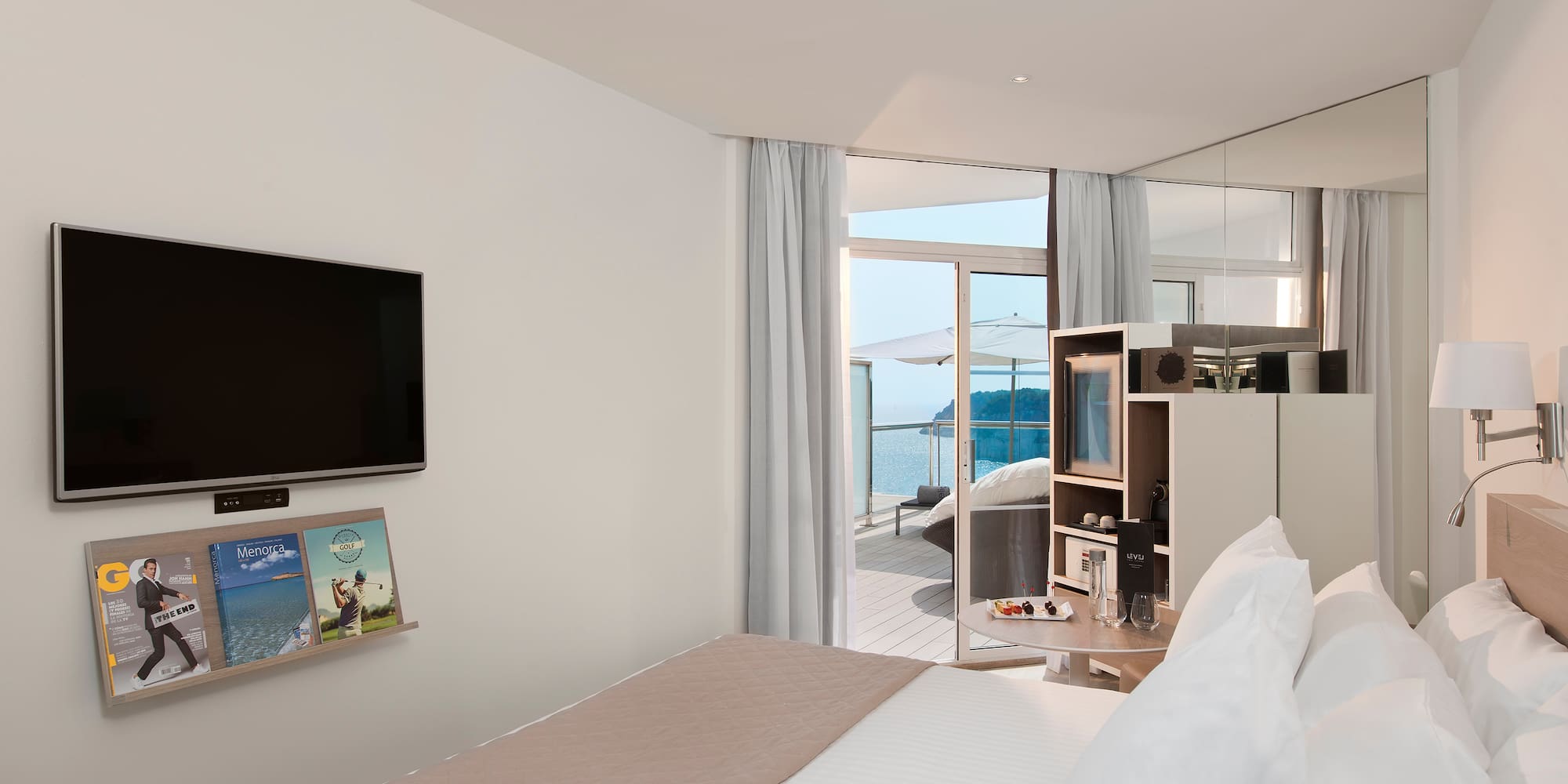 a room with a bed and a television