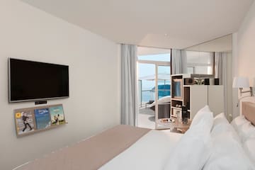 a room with a bed and a television