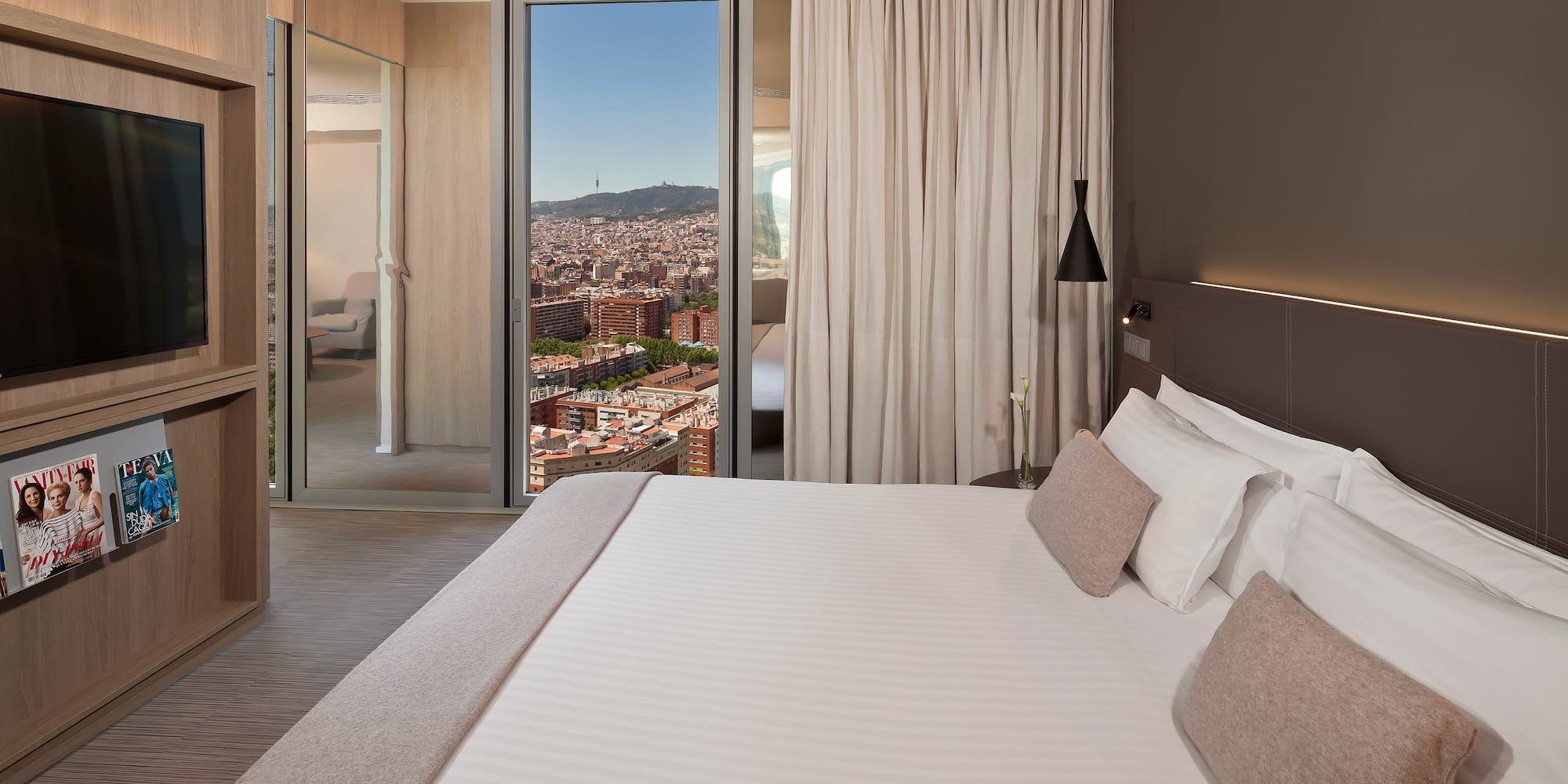 a bed with a view of a city