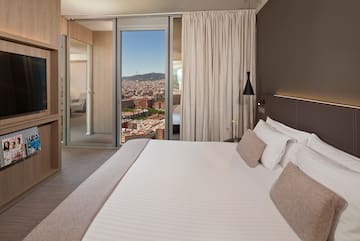 a bed with a view of a city