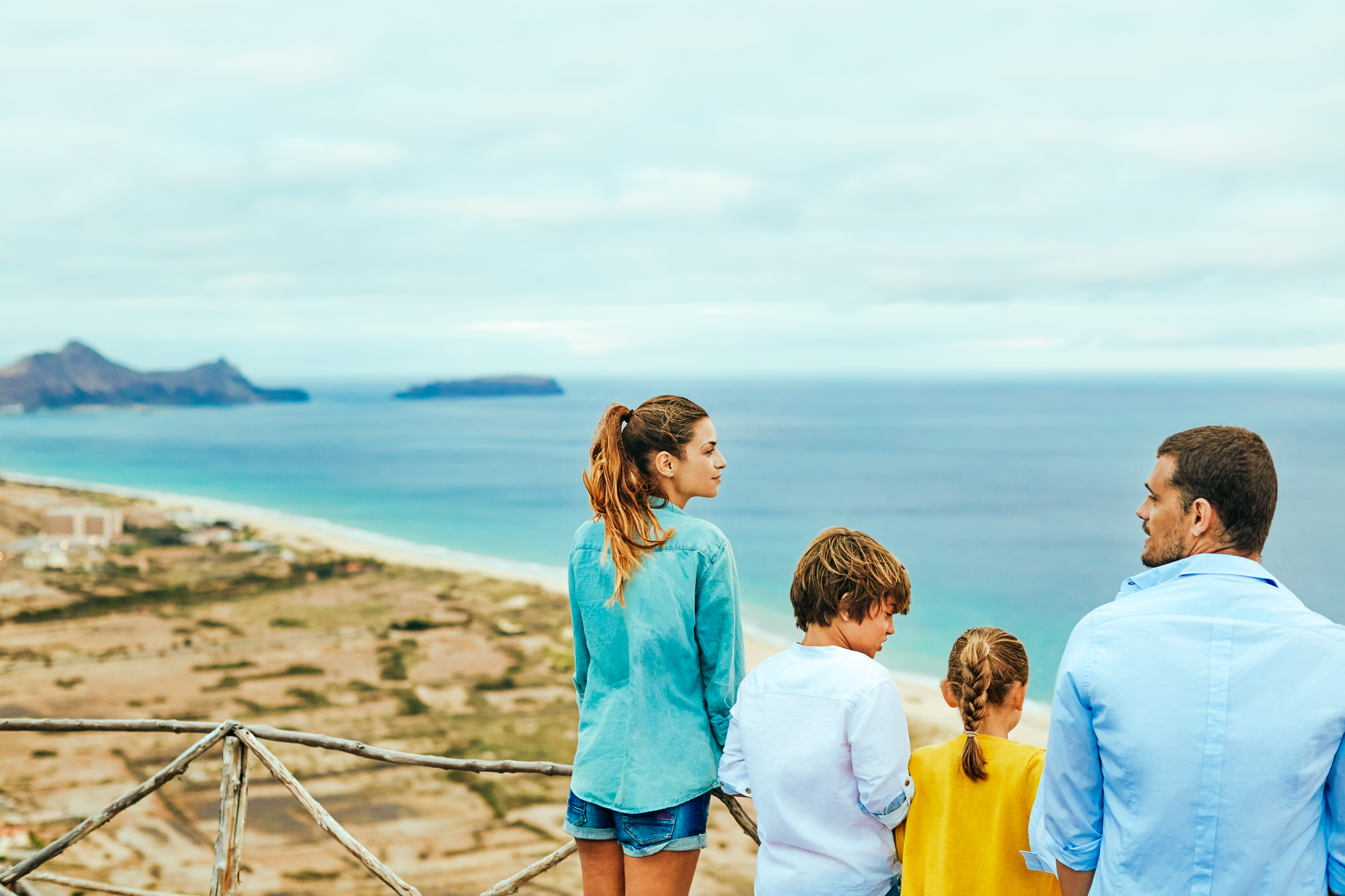 a group of people looking at a beach