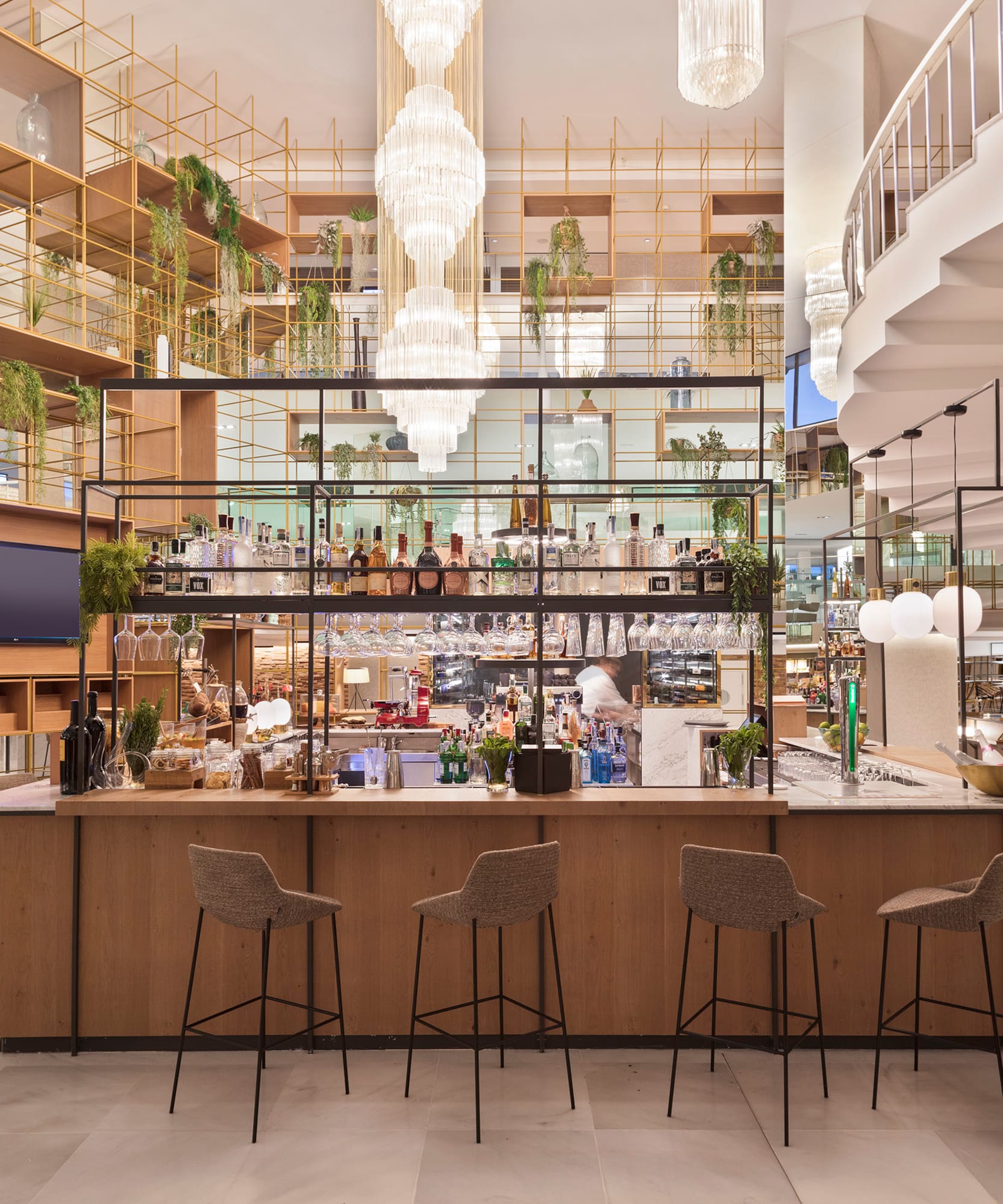 a bar with chairs and a staircase