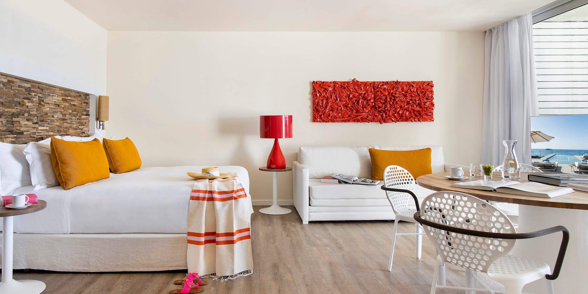 a room with a bed and a table and chairs